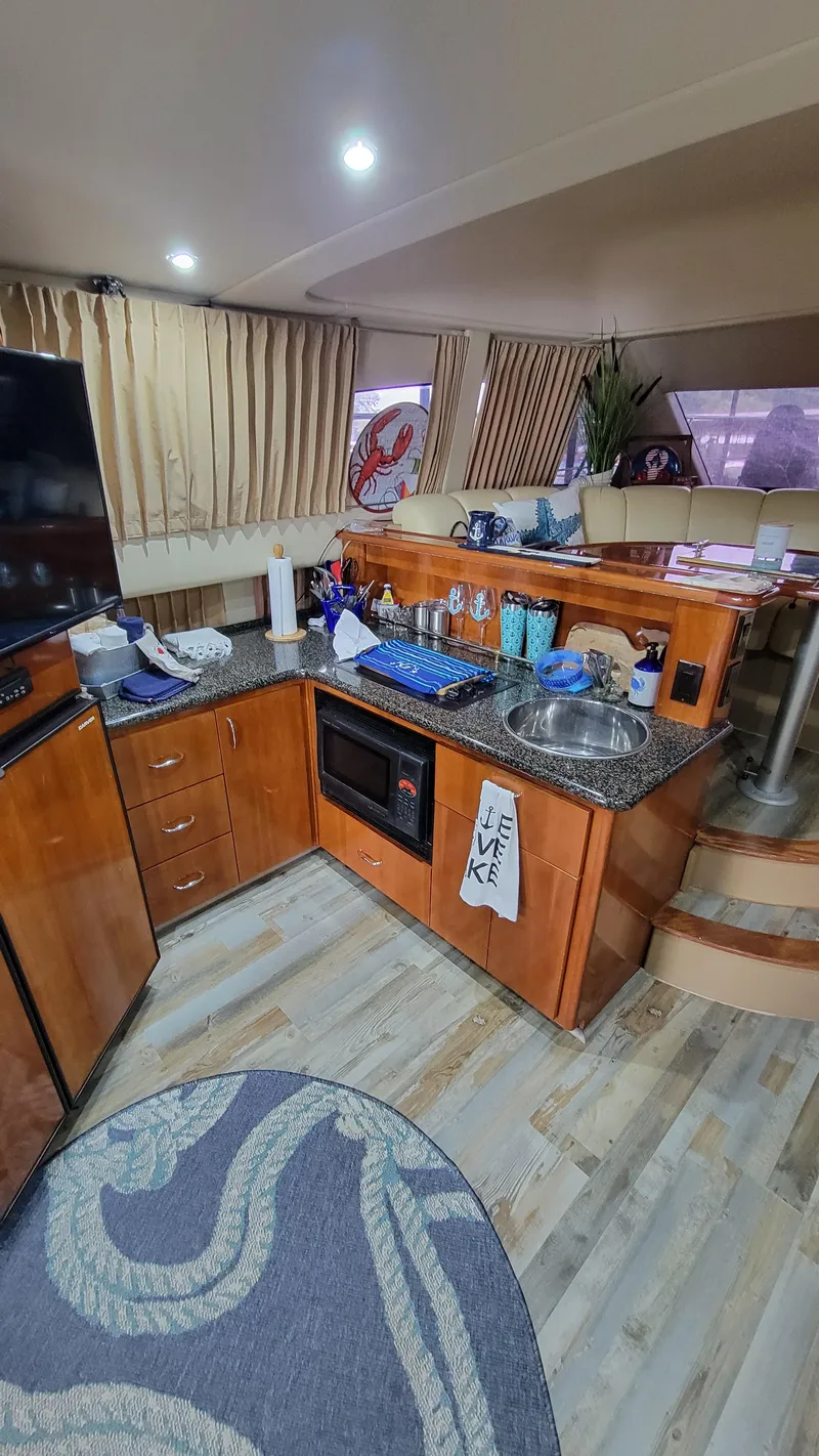 Slide: The Image of Interior of 2004 Carver 360 Sport Sedan with modern kitchen and cozy seating area. - 24