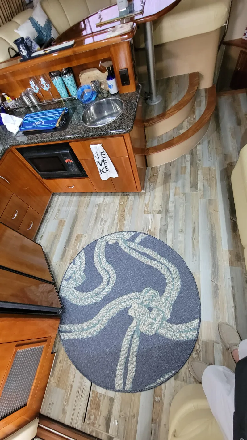 Slide: The Image of Interior of a 2004 Carver 360 Sport Sedan with wood flooring and nautical-themed decor. - 25