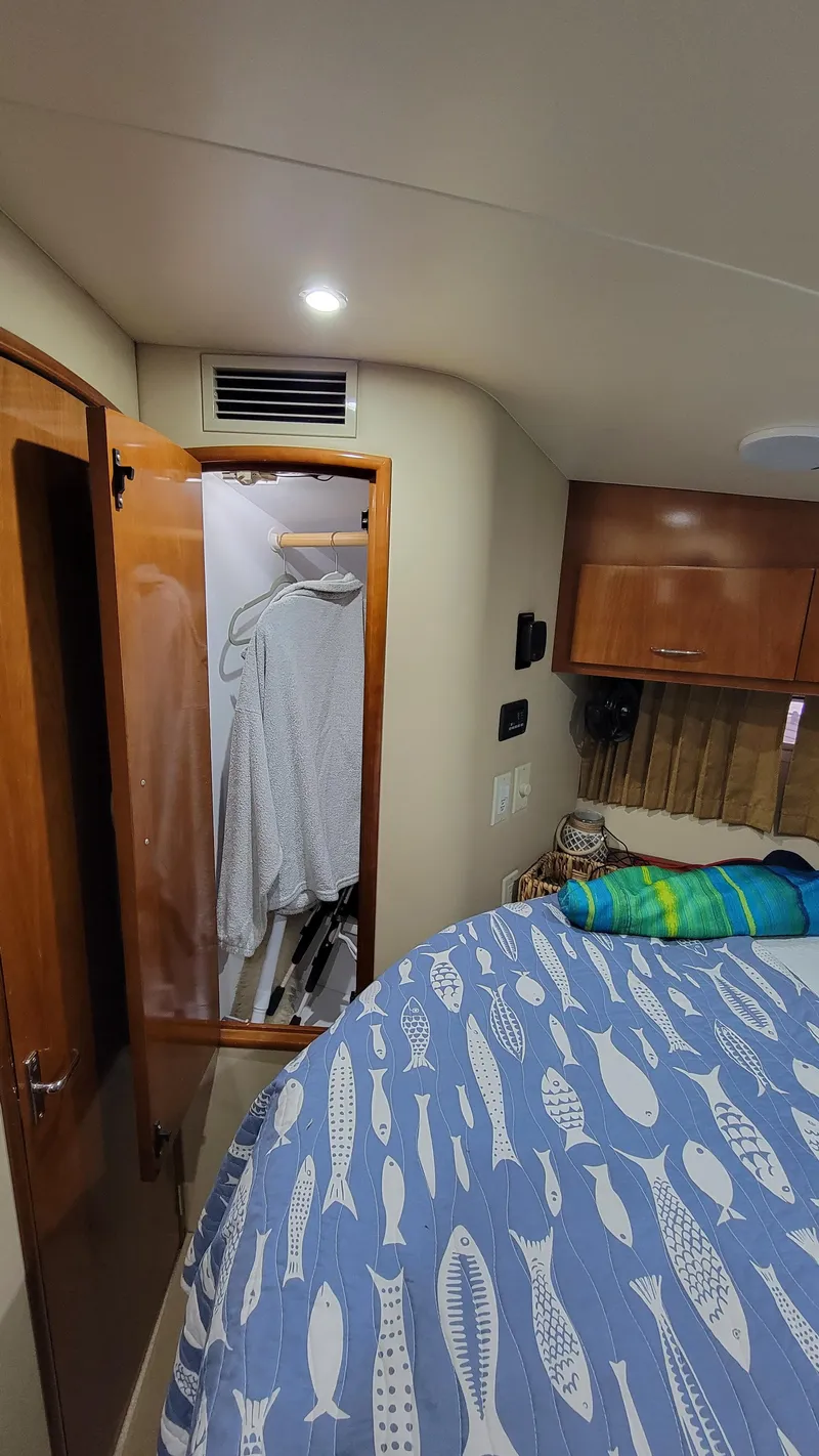 Slide: The Image of Interior of 2004 Carver 360 Sport Sedan with closet and fish-patterned bedspread. - 32