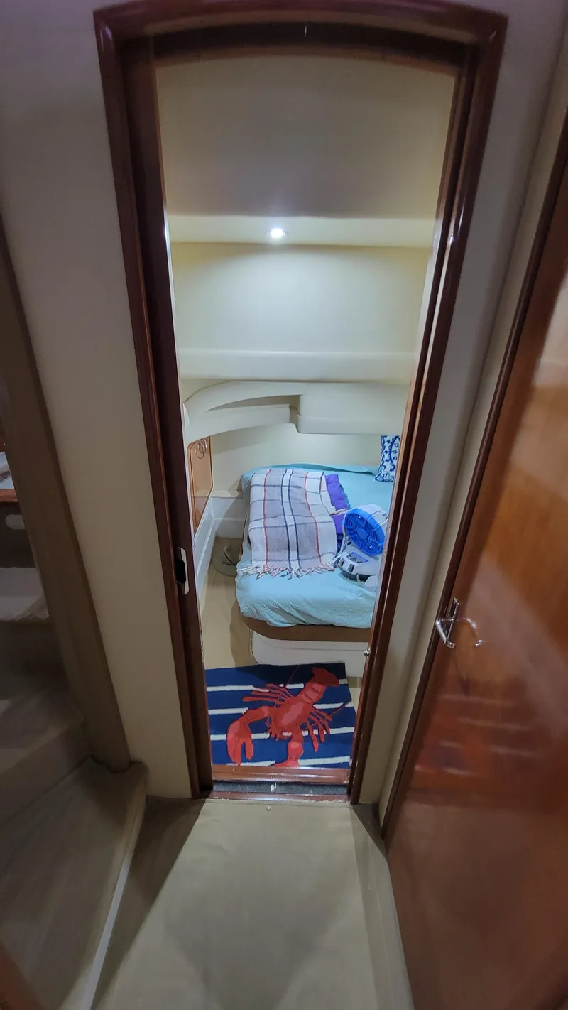 Slide: The Image of Interior cabin of a 2004 Carver 360 Sport Sedan with cozy bedding and nautical decor. - 36