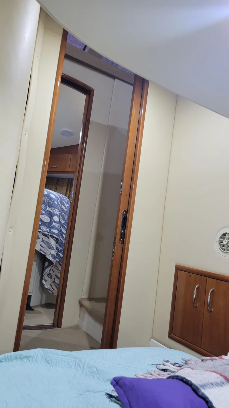 Slide: The Image of Interior of 2004 Carver 360 Sport Sedan with cozy bedroom and wooden cabinetry. - 38