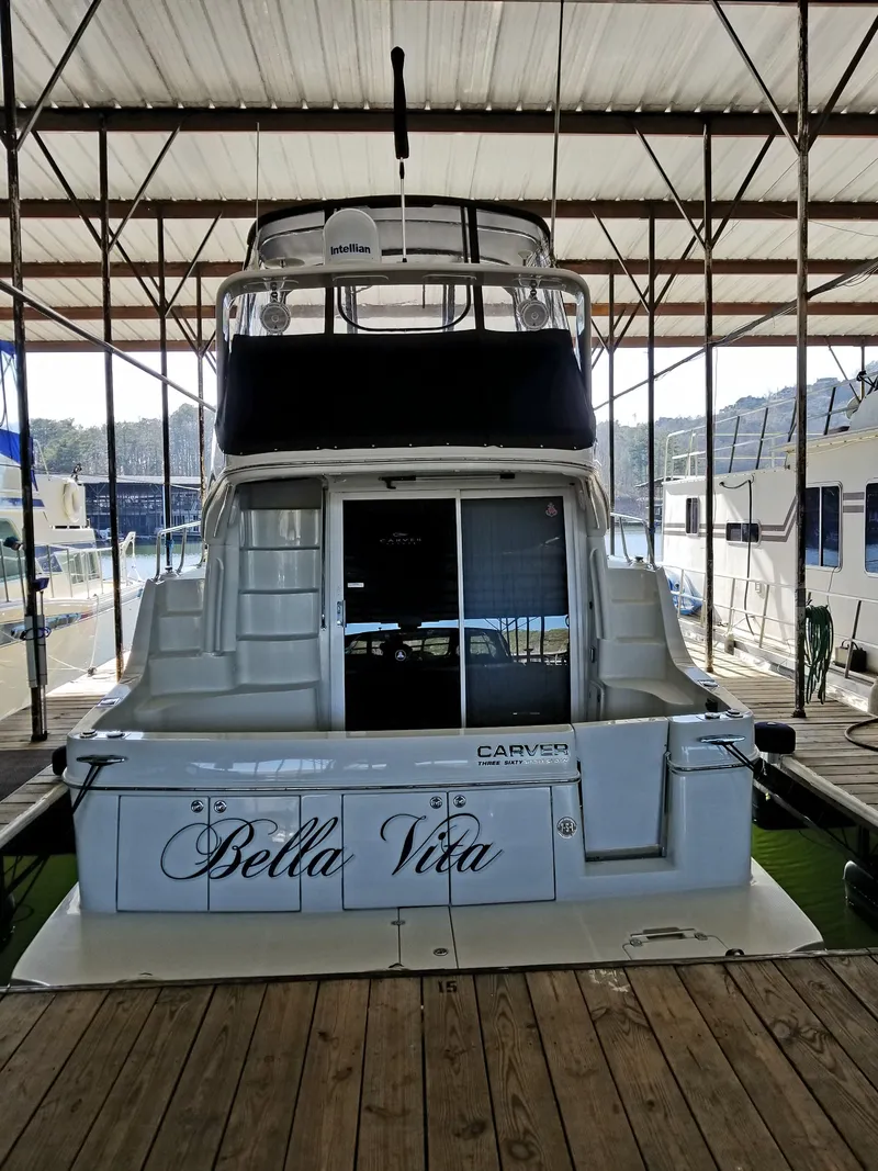 Slide: The Image of 2004 Carver 360 Sport Sedan yacht named "Bella Vita" docked in a marina. - 4