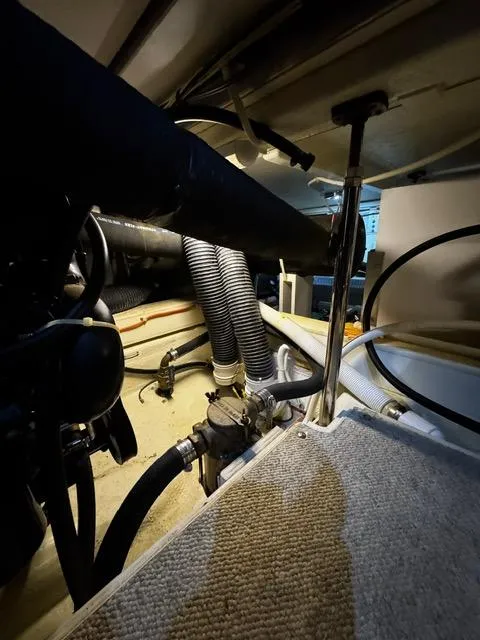 Slide: The Image of Engine room of a 2004 Carver 360 Sport Sedan with visible hoses and components. - 44