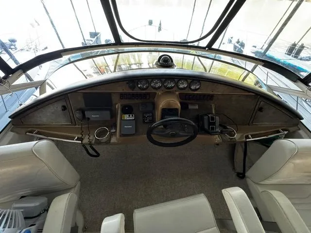 Slide: The Image of 2004 Carver 360 Sport Sedan helm with steering wheel, gauges, and controls. - 7