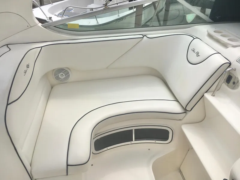 Slide: The Image of Luxurious white seating on 2004 Sea Ray 280 Sundancer boat, featuring elegant design and comfort. - 11
