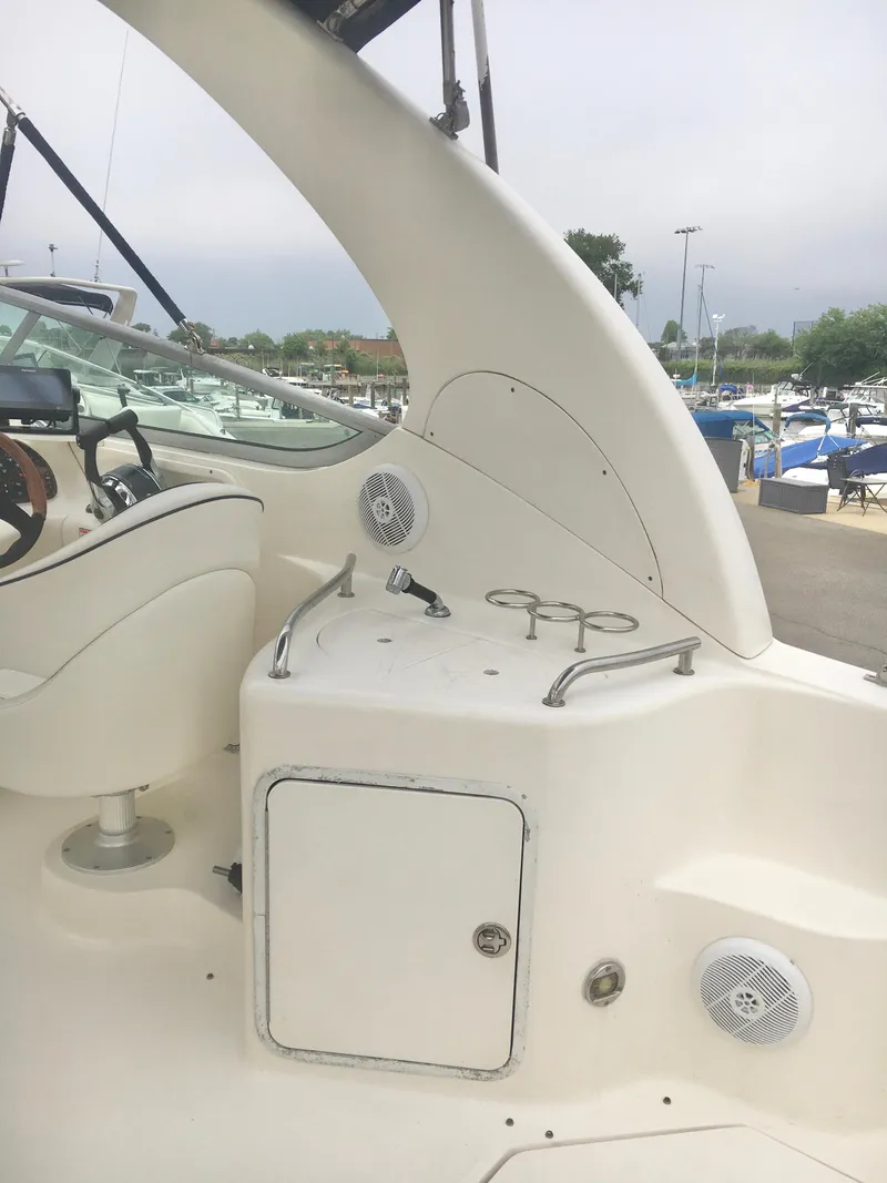 Slide: The Image of 2004 Sea Ray 280 Sundancer boat interior with seating and control panel. - 12