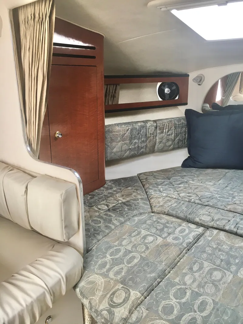 Slide: The Image of Interior of 2004 Sea Ray 280 Sundancer with cozy seating and elegant wood accents. - 16