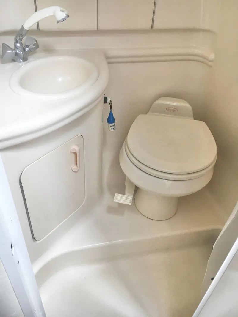 Slide: The Image of 2004 Sea Ray 280 Sundancer bathroom with sink and toilet. - 21