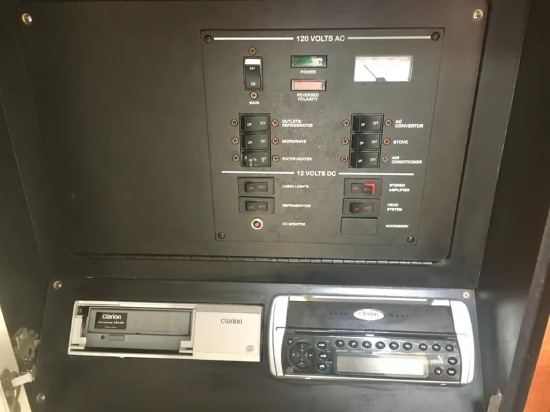 Slide: The Image of Electrical control panel and audio system in 2004 Sea Ray 280 Sundancer boat. - 23