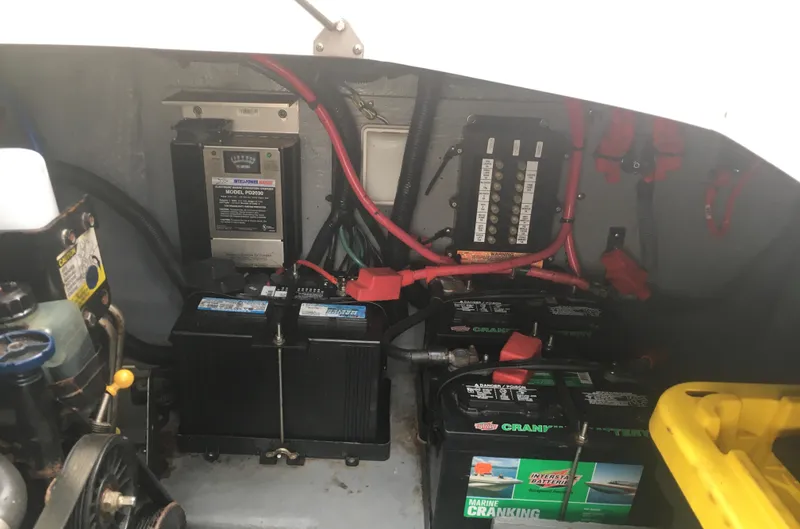 Slide: The Image of Engine compartment of a 2004 Sea Ray 280 Sundancer with batteries and wiring. - 28