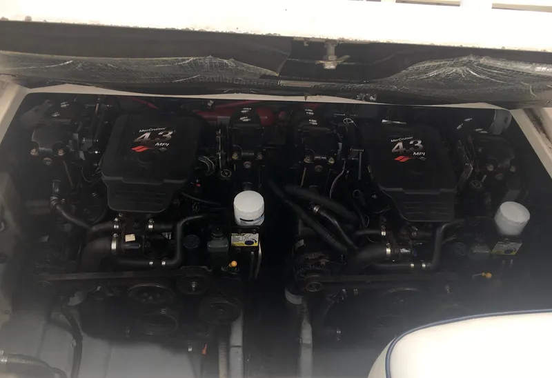 Slide: The Image of Twin engines of a 2004 Sea Ray 280 Sundancer boat, showcasing mechanical components. - 31