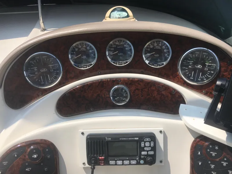 Slide: The Image of Dashboard of a 2004 Sea Ray 280 Sundancer boat with gauges and radio. - 8