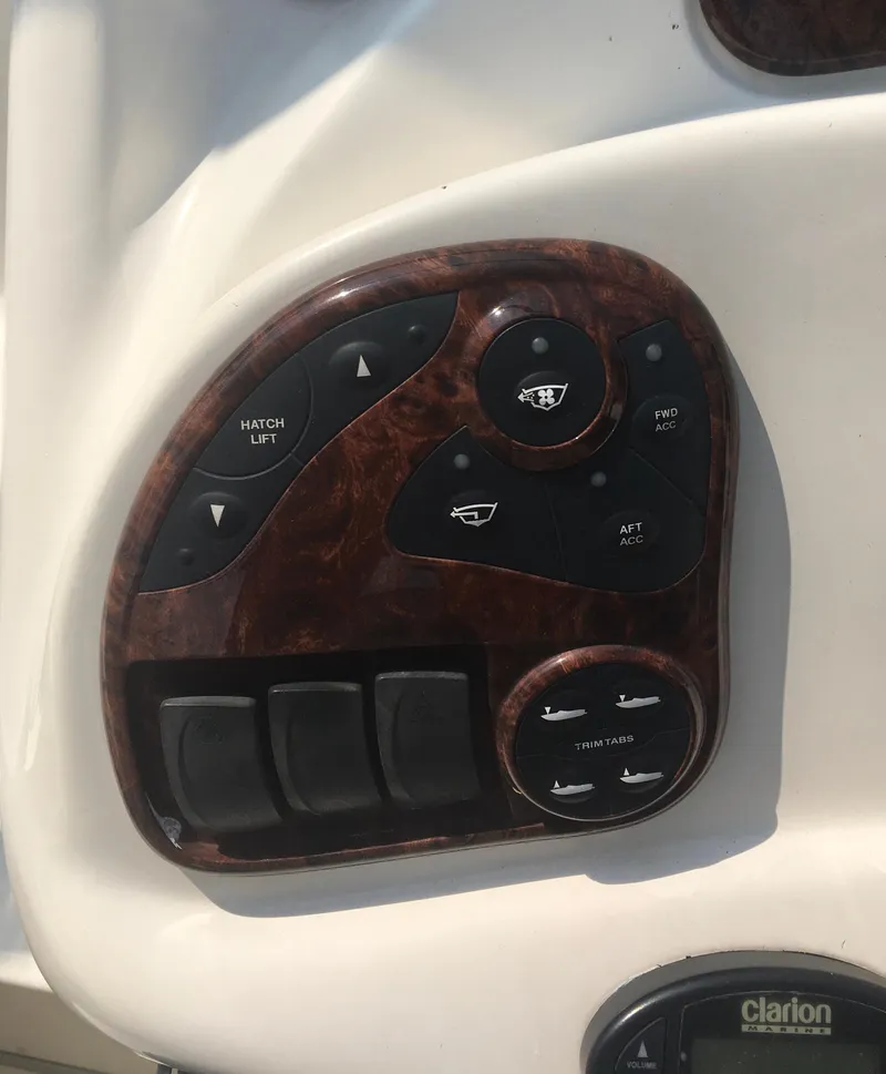 Slide: The Image of Control panel of 2004 Sea Ray 280 Sundancer boat with various switches and buttons. - 9