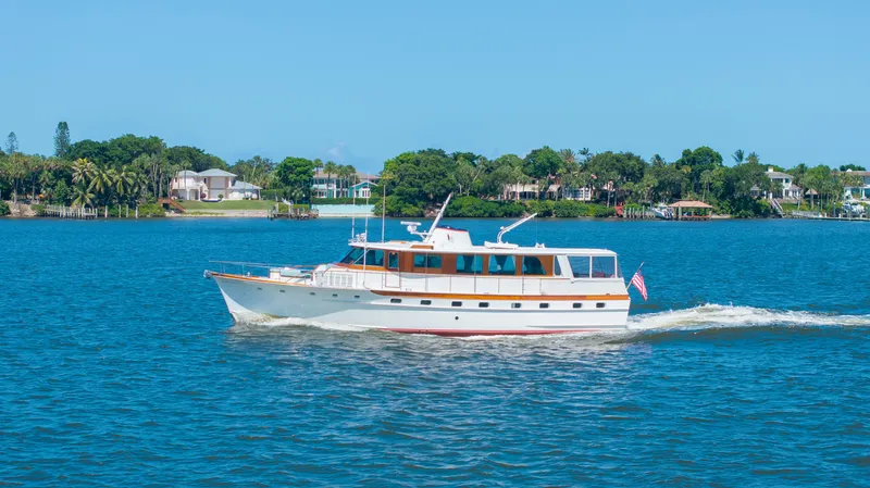 The Image of 1970 Trumpy houseboat cruising on blue water, showcasing classic design and elegance. - 0