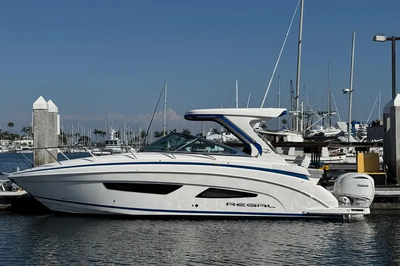 Slide: The Image of 2026 Regal 33 XO boat docked at marina, showcasing sleek design and modern features. - 1