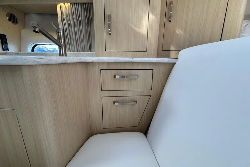 Slide: The Image of Interior of 2026 Regal 33 XO yacht with modern cabinetry and seating. - 105