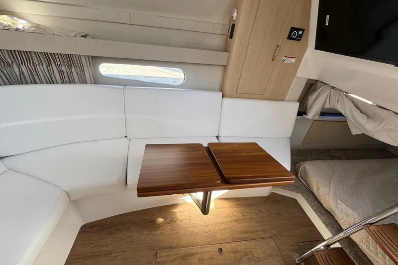 Slide: The Image of 2026 Regal 33 XO interior with white seating, wooden table, and modern design. - 121