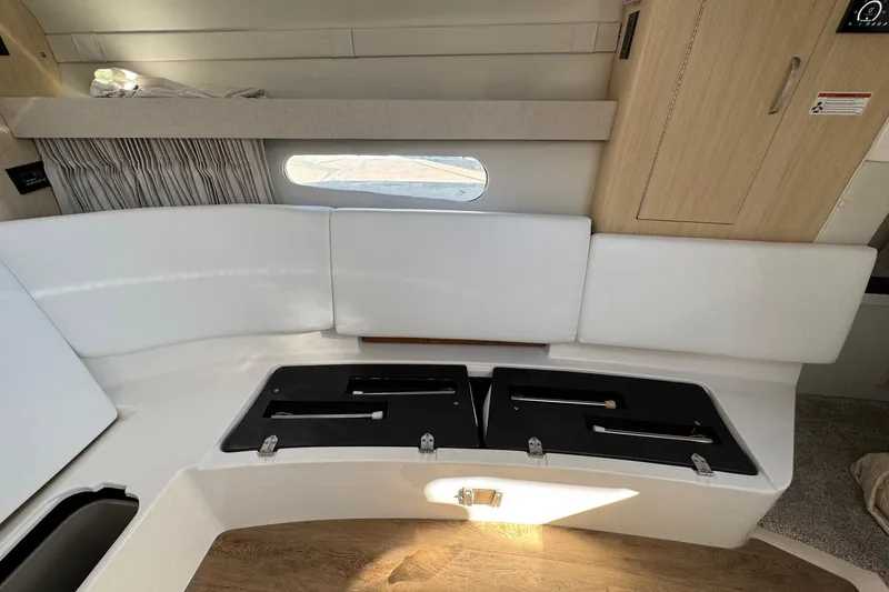 Slide: The Image of Interior of 2026 Regal 33 XO boat with white seating and storage compartments. - 125