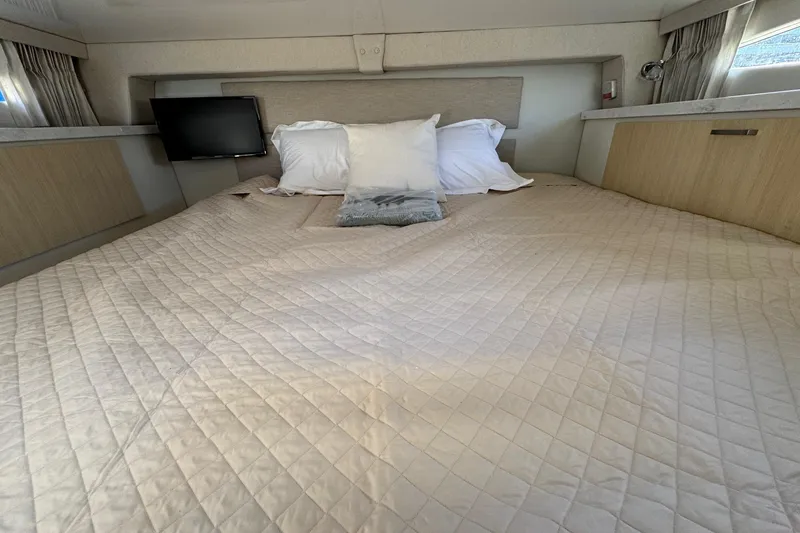 Slide: The Image of Luxurious cabin interior of 2026 Regal 33 XO yacht with cozy bedding and TV. - 134