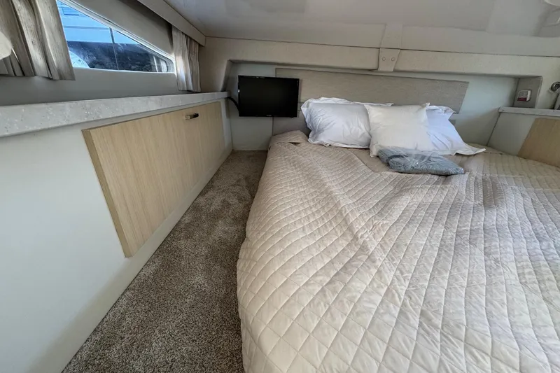 Slide: The Image of Luxurious interior cabin of 2026 Regal 33 XO yacht with cozy bedding. - 135