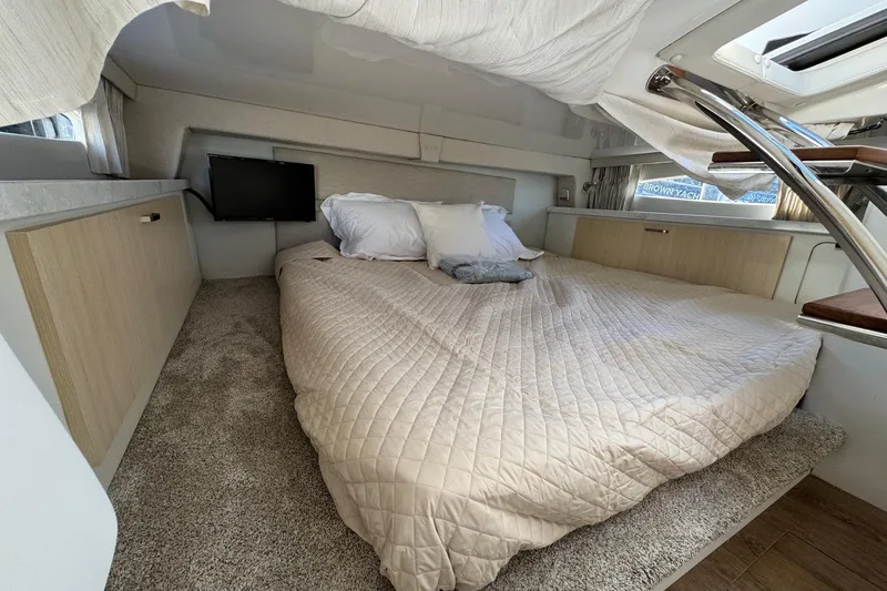 Slide: The Image of Cozy cabin interior of 2026 Regal 33 XO yacht with bed and TV. - 136