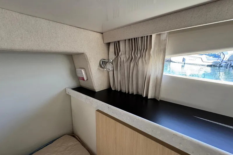 Slide: The Image of Interior of 2026 Regal 33 XO yacht with window view and elegant curtains. - 144