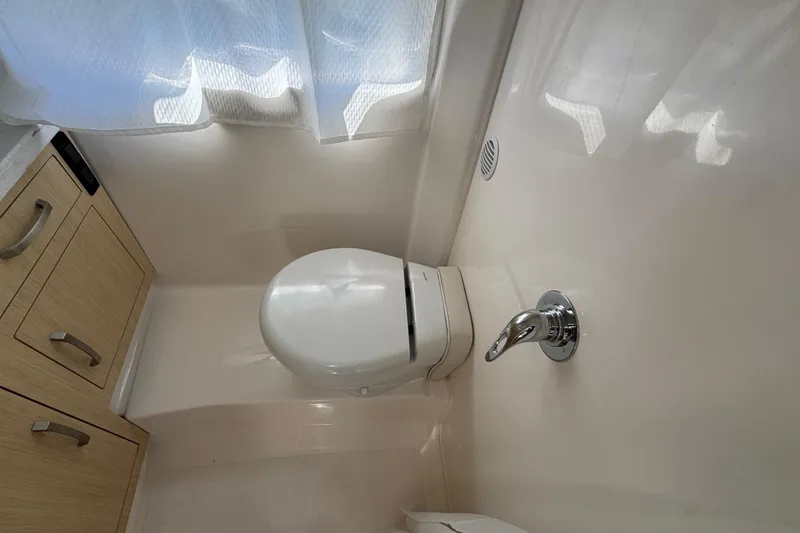 Slide: The Image of Bathroom interior of 2026 Regal 33 XO boat with modern fixtures. - 148