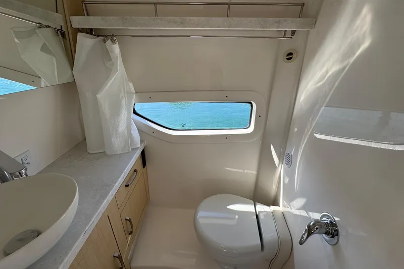 Slide: The Image of Luxurious bathroom in 2026 Regal 33 XO yacht with ocean view window. - 149