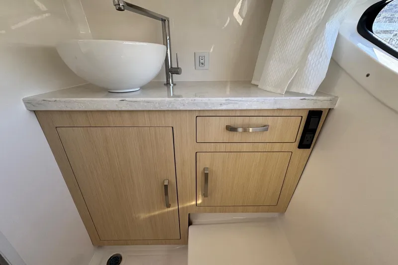Slide: The Image of Modern bathroom vanity in 2026 Regal 33 XO boat with vessel sink and wood cabinetry. - 150