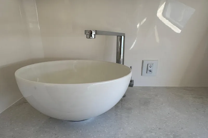 Slide: The Image of Modern white sink with sleek faucet in 2026 Regal 33 XO boat interior. - 156