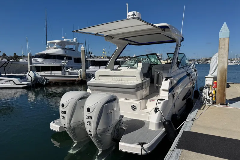Slide: The Image of 2026 Regal 33 XO boat docked with twin Yamaha 350 engines, sunny marina setting. - 35