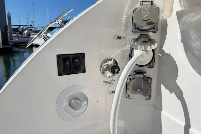 Slide: The Image of 2026 Regal 33 XO boat utility connections and controls at marina dock. - 42