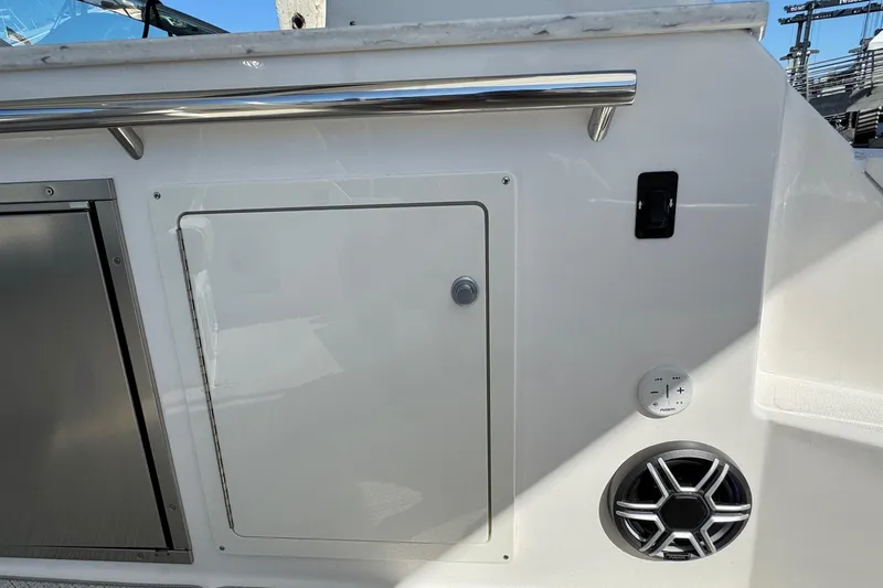 Slide: The Image of 2026 Regal 33 XO boat interior with storage compartment and speaker. - 46