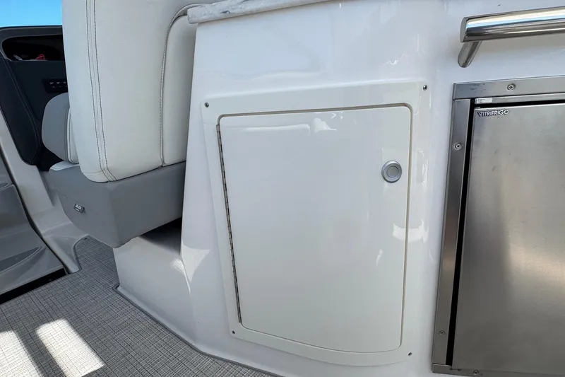 Slide: The Image of 2026 Regal 33 XO boat interior with white seating and stainless steel compartment. - 50