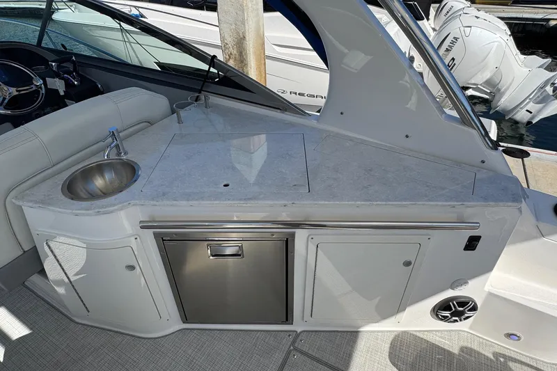 Slide: The Image of 2026 Regal 33 XO boat interior with sink, countertop, and storage. - 52