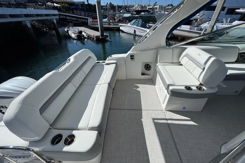 Slide: The Image of 2026 Regal 33 XO yacht interior with luxurious seating and cup holders. - 61