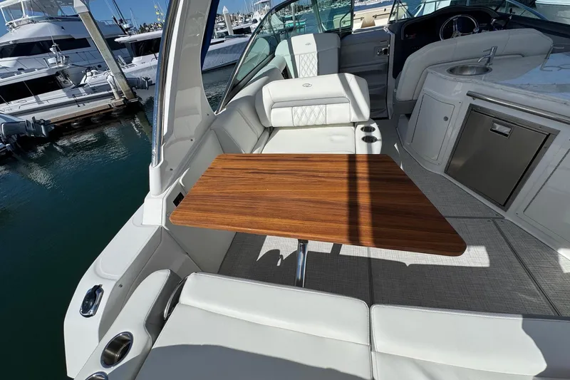 Slide: The Image of Luxurious 2026 Regal 33 XO yacht interior with elegant seating and wooden table. - 65