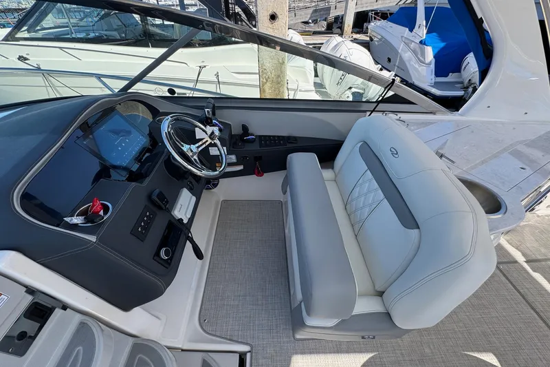 Slide: The Image of 2026 Regal 33 XO boat cockpit with modern steering and plush seating. - 71