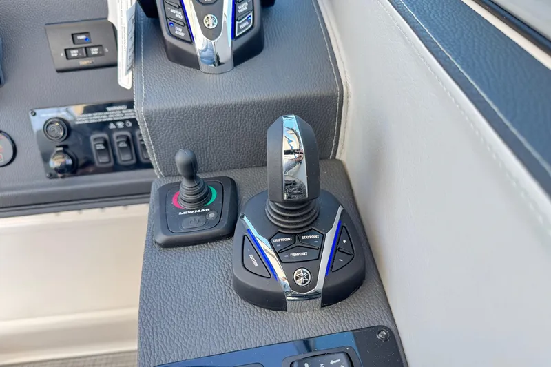 Slide: The Image of Control panel of 2026 Regal 33 XO boat with joystick and buttons. - 76
