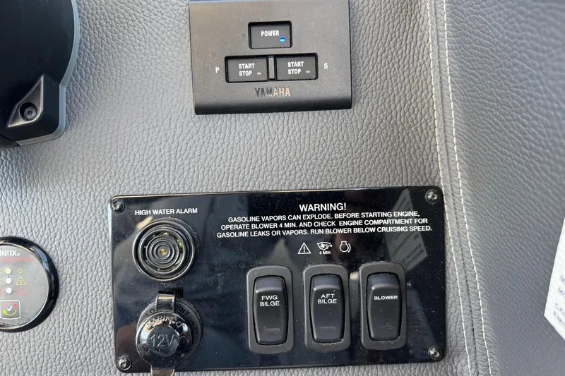 Slide: The Image of Control panel of 2026 Regal 33 XO boat with warning labels and switches. - 78