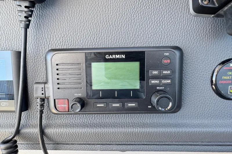 Slide: The Image of Garmin marine radio on 2026 Regal 33 XO boat dashboard. - 79