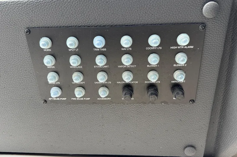 Slide: The Image of Control panel of a 2026 Regal 33 XO boat with labeled switches and buttons. - 83