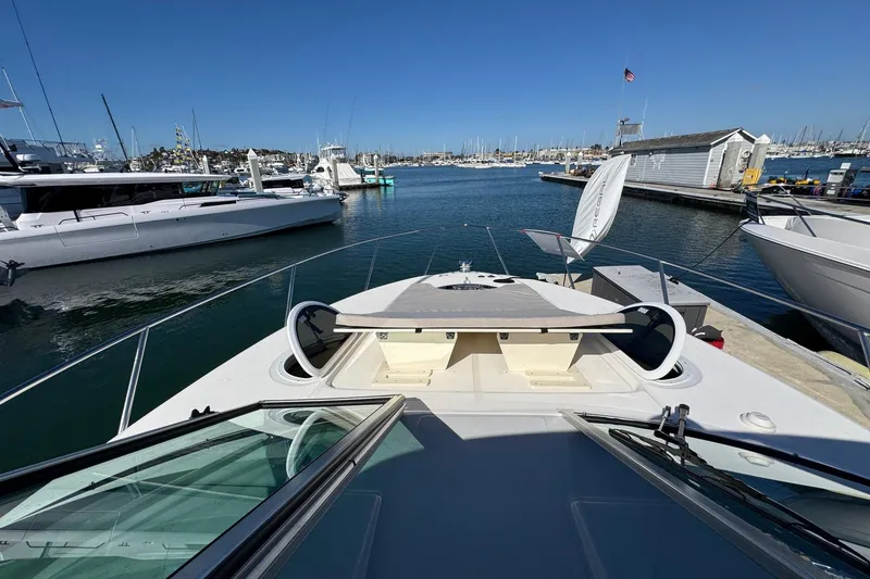 Slide: The Image of 2026 Regal 33 XO yacht docked at marina, clear sky, calm waters. - 85