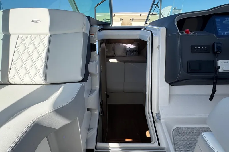 Slide: The Image of 2026 Regal 33 XO boat interior with luxurious seating and cabin entrance. - 92