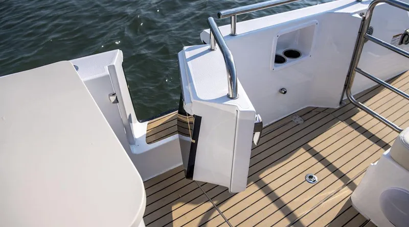 Slide: The Image of 2026 MJM 38x boat deck with seating, American flag, and docked engines. - 14