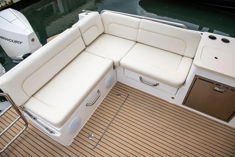 Slide: The Image of MJM 3 2026 boat deck with open gate, wooden flooring, and railing by the water. - 15