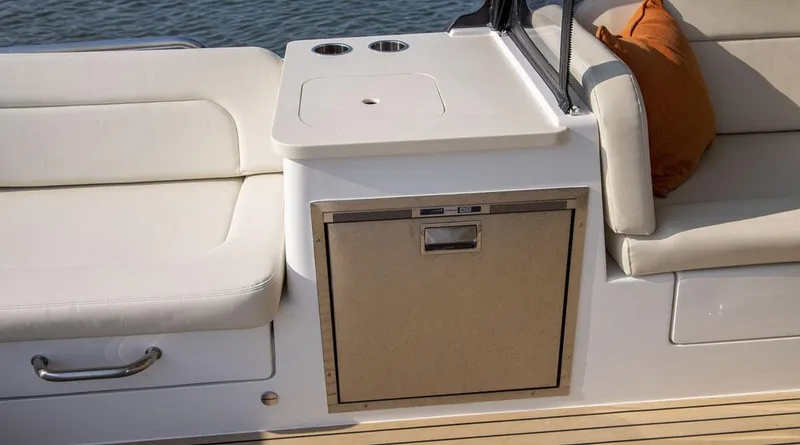 Slide: The Image of Luxury seating area on MJM 3 boat, featuring built-in storage and cup holders, 2026 model. - 16
