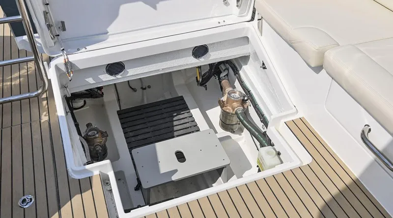 Slide: The Image of Open engine compartment of 2026 MJM 3 boat with visible components and teak deck. - 17