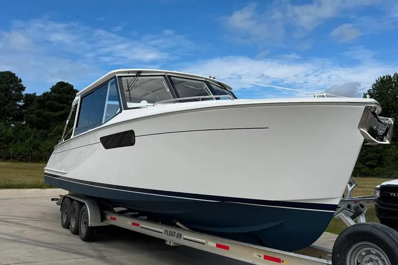 Slide: The Image of Modern MJM 3 yacht interior with wooden cabinetry, sleek countertop, and window, 2026 model. - 28