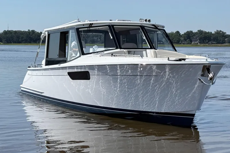 Slide: The Image of 2026 MJM 38x boat cruising on calm water under clear sky. - 3